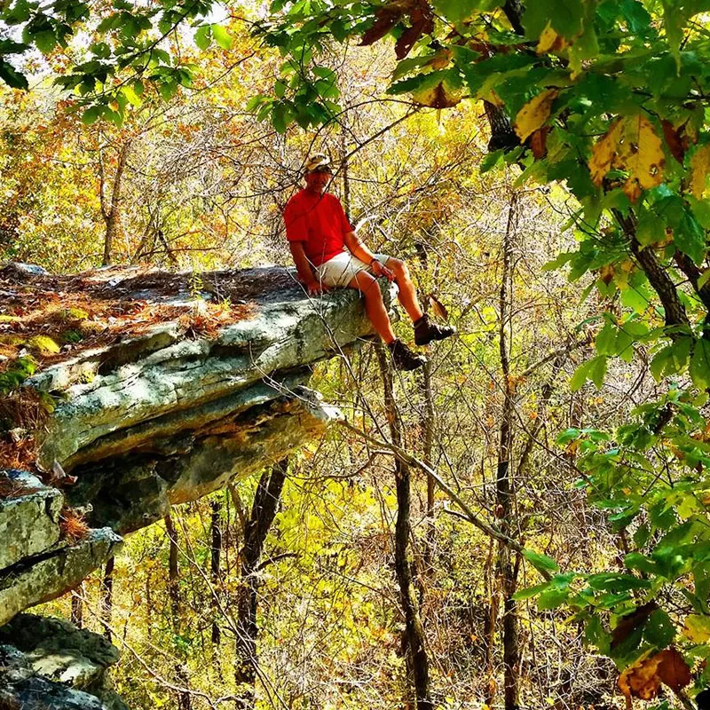 man sitting on a rock